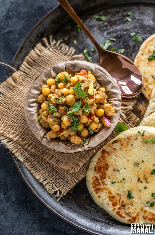 matar chaat in a bowl made of leaves and kulcha placed on the side