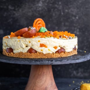 mithai cheesecake on a wooden cake platter