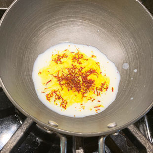 small pan with milk and saffron