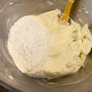 cream cheese with sugar in a stand mixer bowl