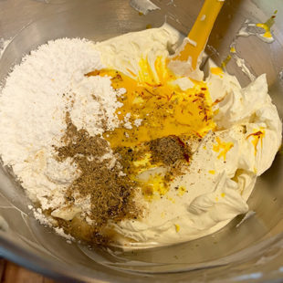 cream cheese, sugar with cardamom powder, saffron milk in the steel bowl of stand mixer