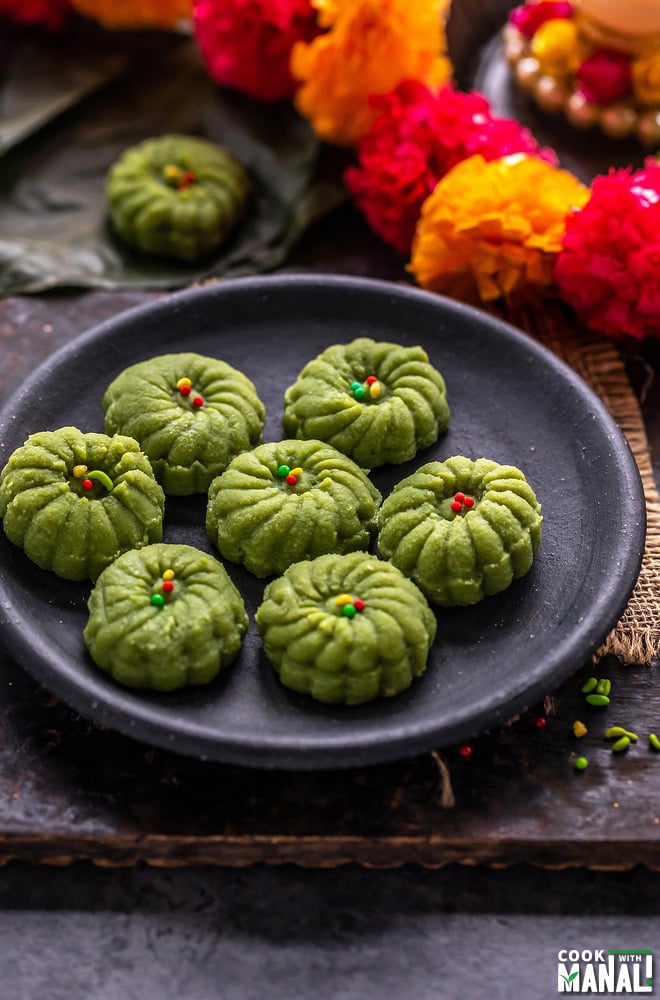 7 paan peda arranged on a plate with string of flower on the side