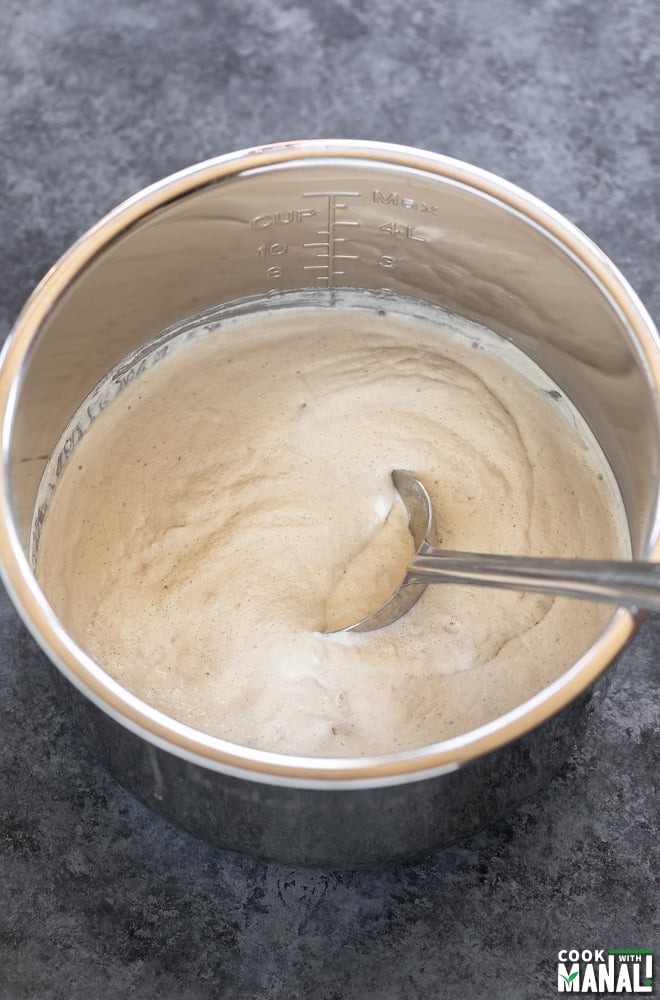 a fermented batter in a steel pot