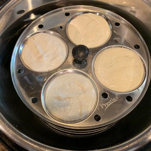 idli plates filled with idli batter