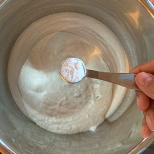teaspoon of salt being added to blender