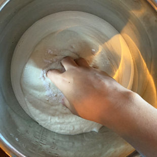 hand mixing batter in a bowl