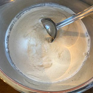 fermented batter with a steel ladle