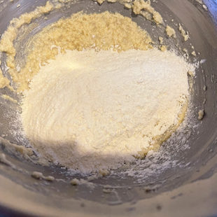 flour being added to cream and butter mixture