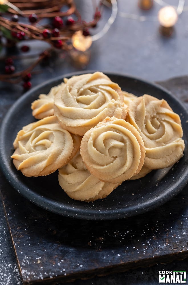 plate of rosette shaped cookies with string lights in the background