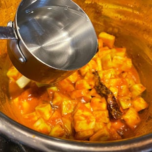 water being added to a curry