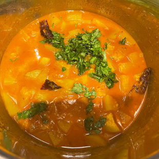 curry in a pot garnished with cilantro