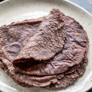 few ragi roti placed on a white plate