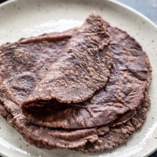 few ragi roti placed on a white plate