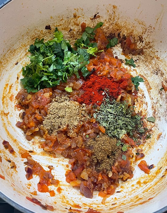 onion tomato masala with dry spices in a pot