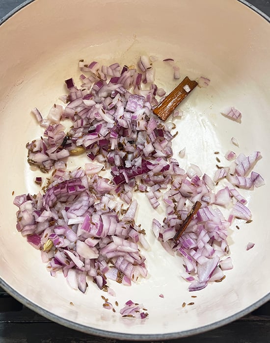 whole spices with onions in a pot