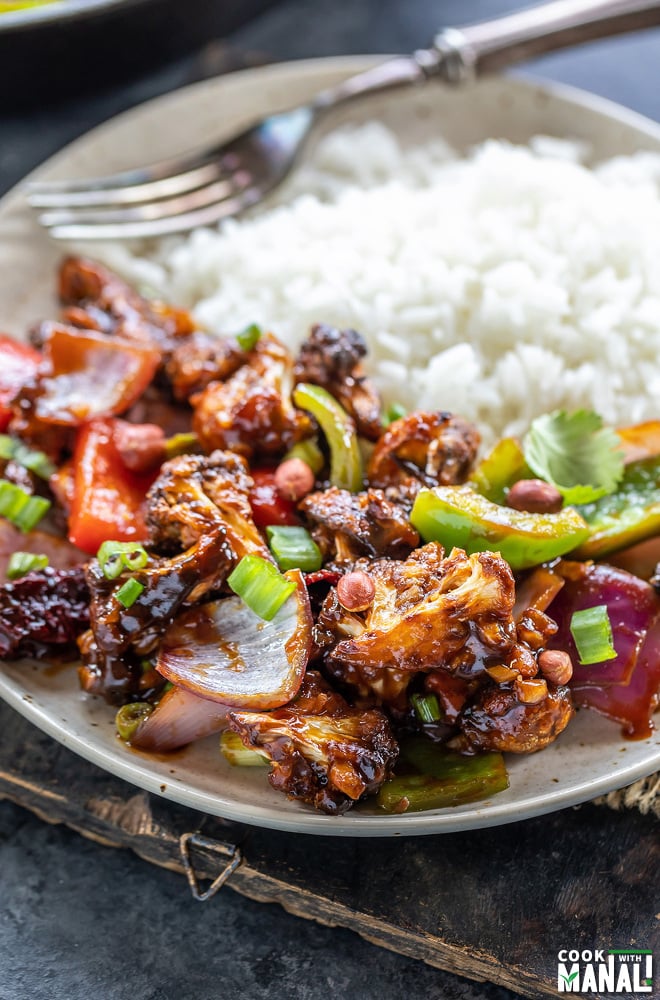 kung pao cauliflower served with white rice on a plate