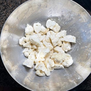 cauliflower florets in a steel bowl