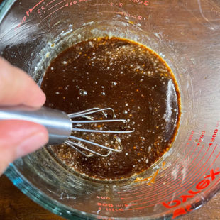 sauce being whisked with a wire whisk