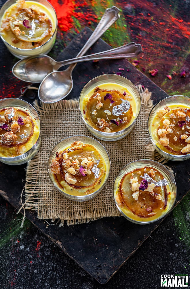 overhead shot of 6 dessert glasses filled with rabdi and malpua