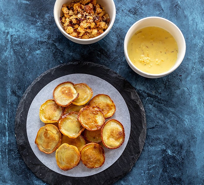 one bowl with rabdi, one with crumble and a plate of mini malpua 