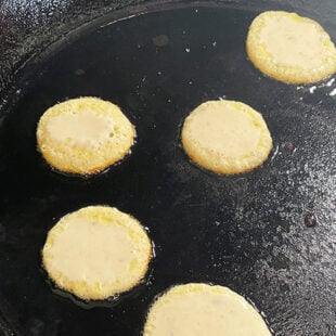 mini malpua being fried in ghee