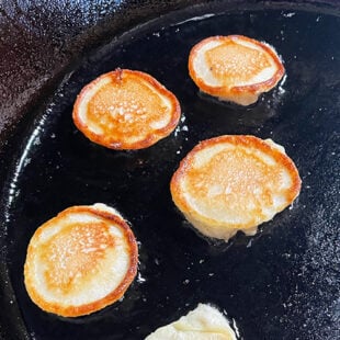 mini malpua being fried in ghee