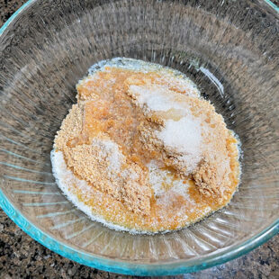bowl with cookie crumbs, sugar and butter