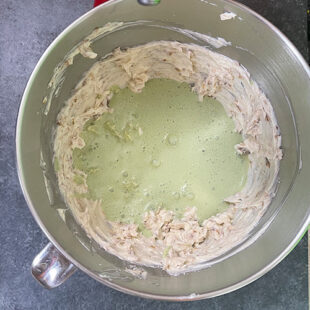 green color paste being added to a mixer