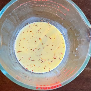 saffron milk in a measuring jar