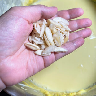 sliced almonds being added to milk