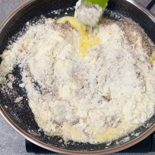 milk powder being added to a pan