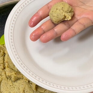 dough ball being rolled in a palm