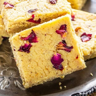 cut burfi topped with dried rose petals