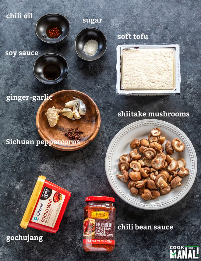 tofu, mushrooms, chili sauce and other ingredients placed on a table