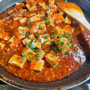 tofu with green onions and chili sauce in a pan