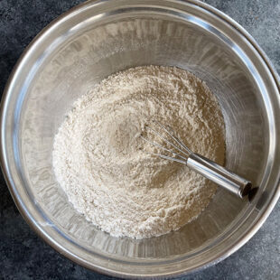 bowl with flour and a wire whisk