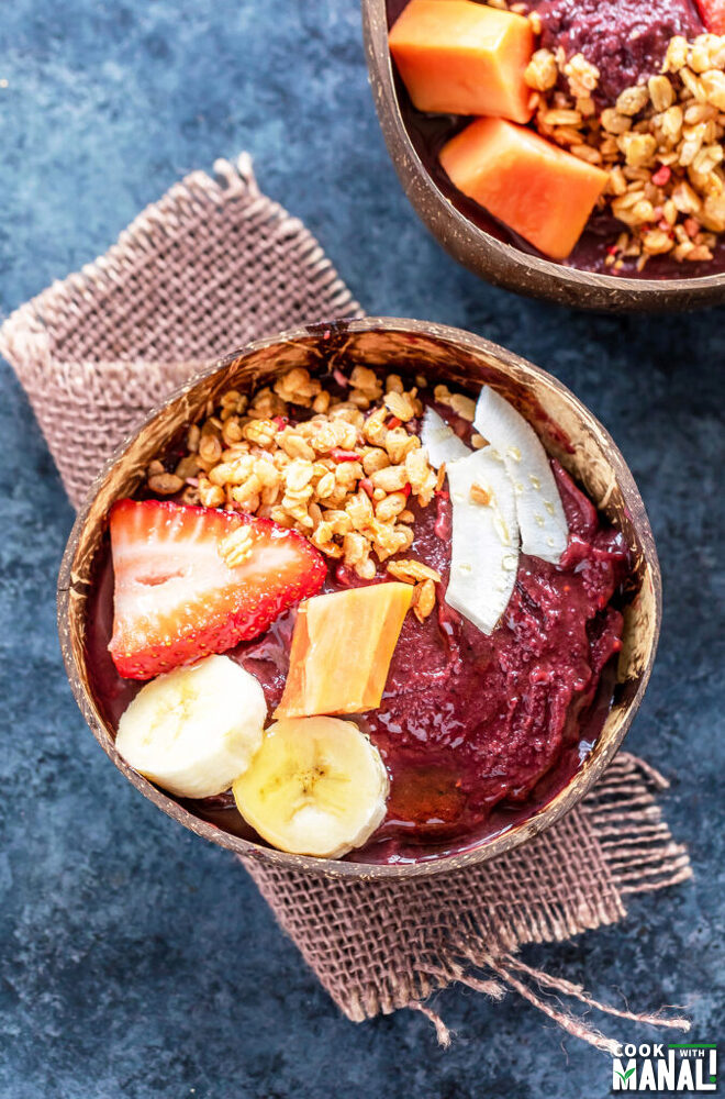 acai bowl topped with strawberries, banana, granola