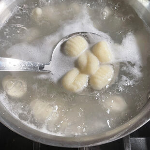 potato gnocchi boiling in a pan