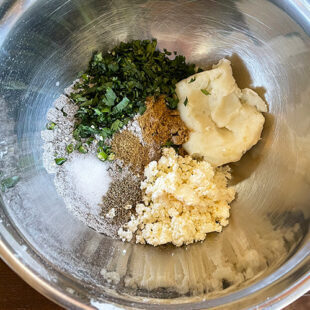 bowl with flour, mashed potato, cilantro, spices, crumbled paneer