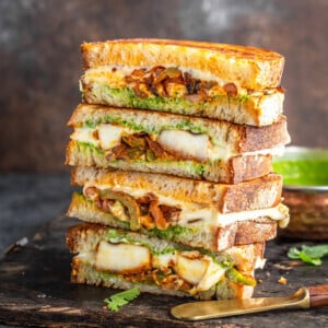 stack of paneer sandwiches cut into half to reveal the inside