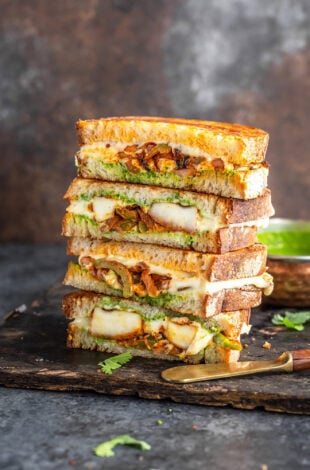 stack of paneer sandwiches cut into half to reveal the inside