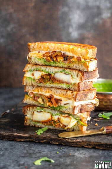stack of paneer sandwiches cut into half to reveal the inside