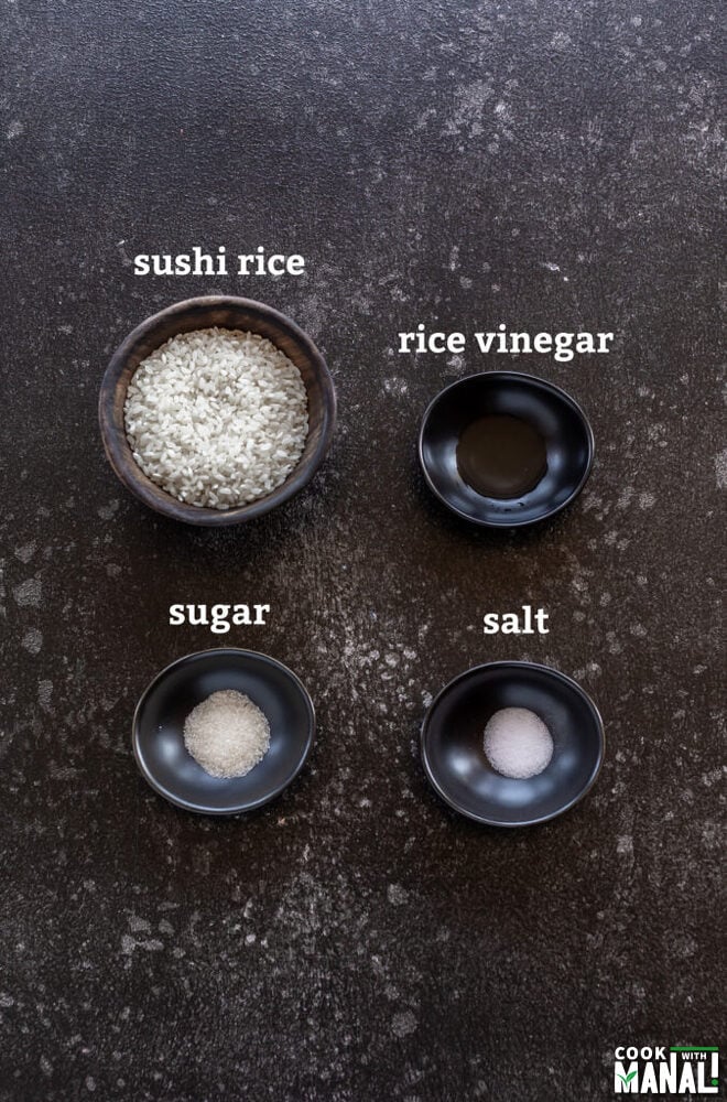 4 small black bowls filled with rice, vinegar, sugar and salt