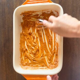 pair of hand whisking a marinade