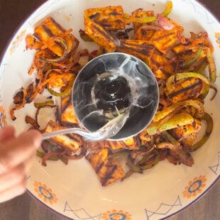 ghee being drizzle on hot charcoal to infuse smoky flavor