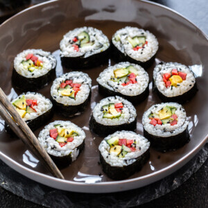 maki rolls filed with cucumber, avocado, carrots placed in a bowl
