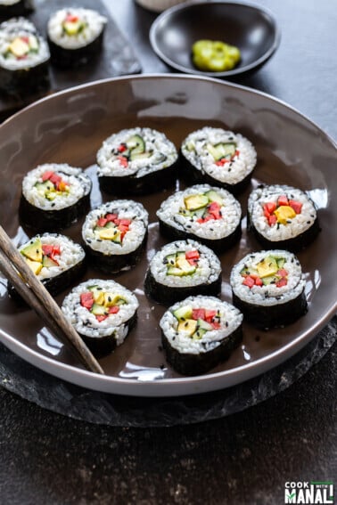 maki rolls filed with cucumber, avocado, carrots placed in a bowl