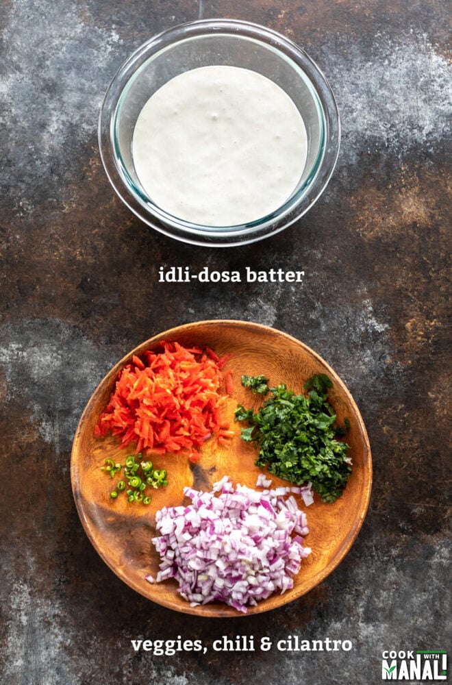 bowl with dosa batter and a plate with chopped onion, cilantro, carrots