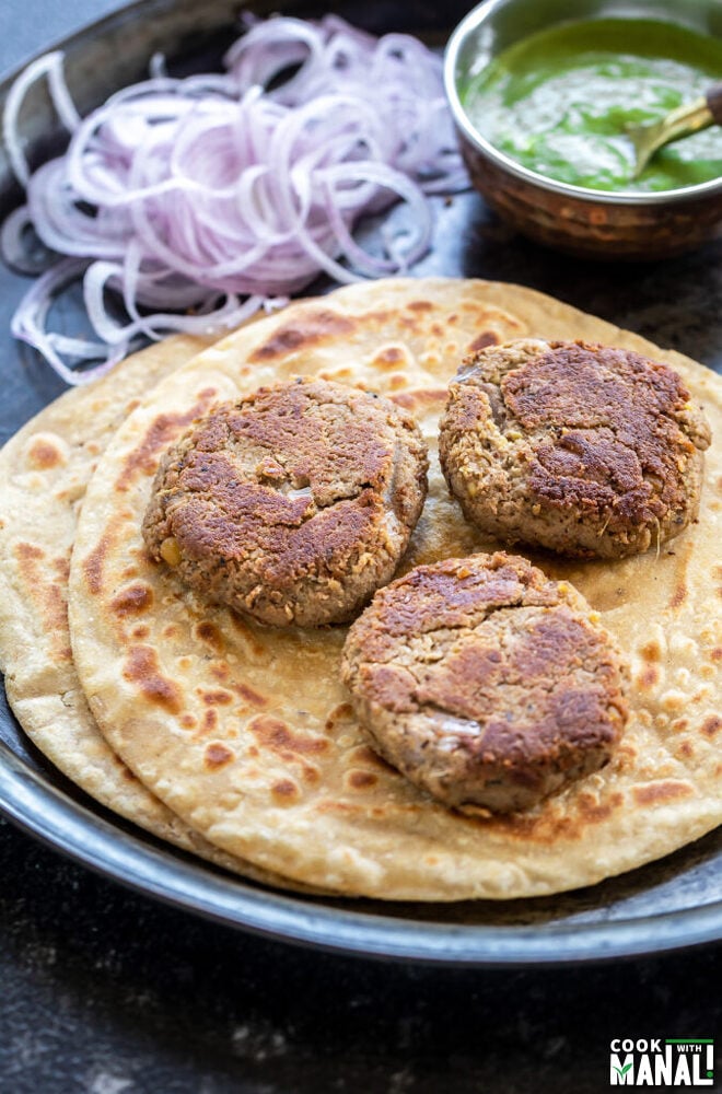 3 kebabs placed on paratha