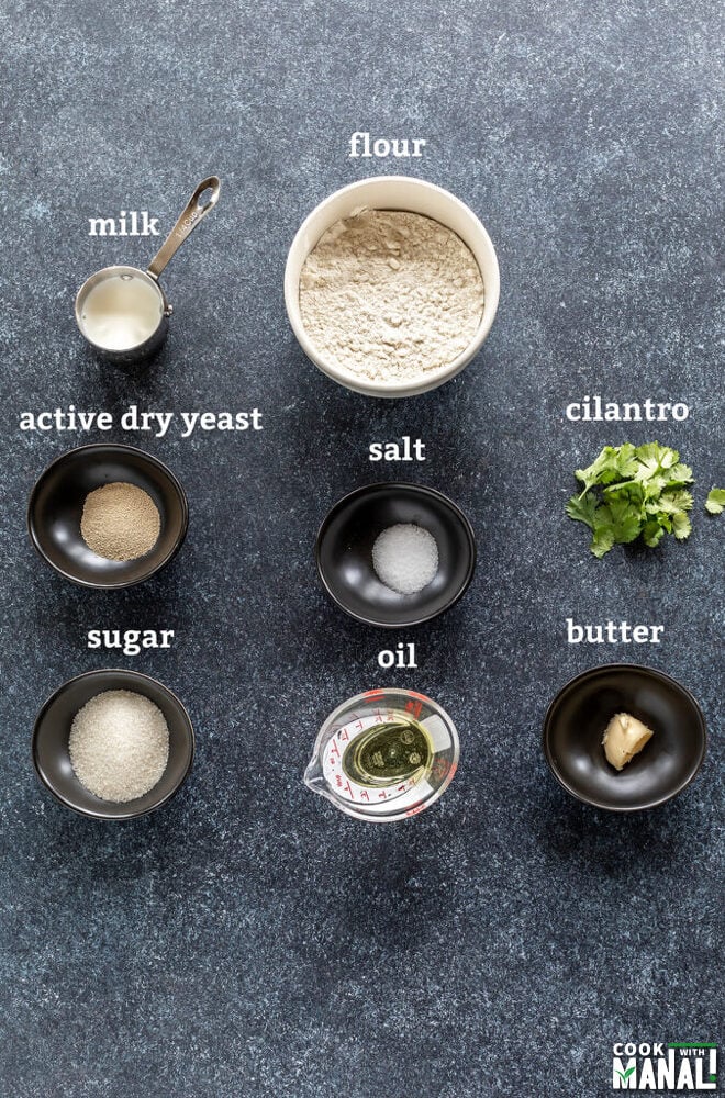 bowls with flour, salt, sugar, yeast arranged on a board